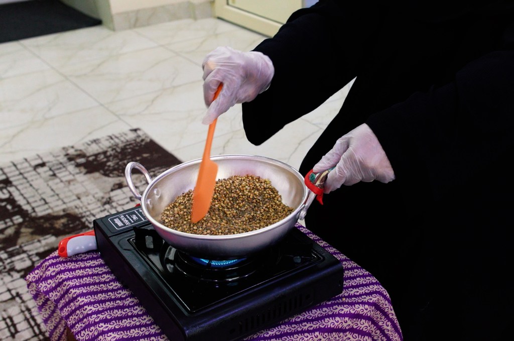 Noora Khalid Musaifer roasts spices before mixing and packaging them in special bottles ready for sale.